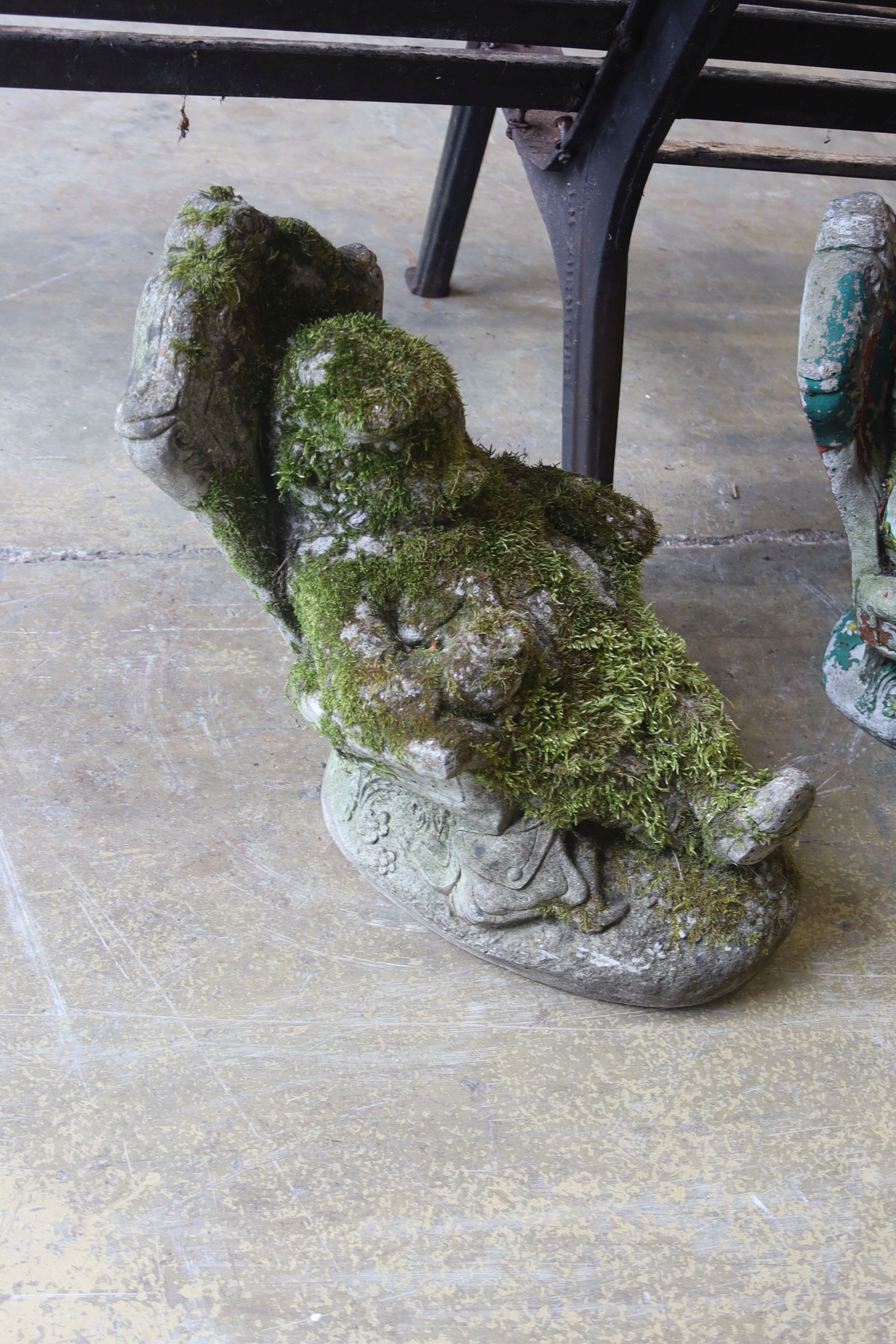 A pair of reconstituted garden ornaments modelled as seated gnomes, height 40cm